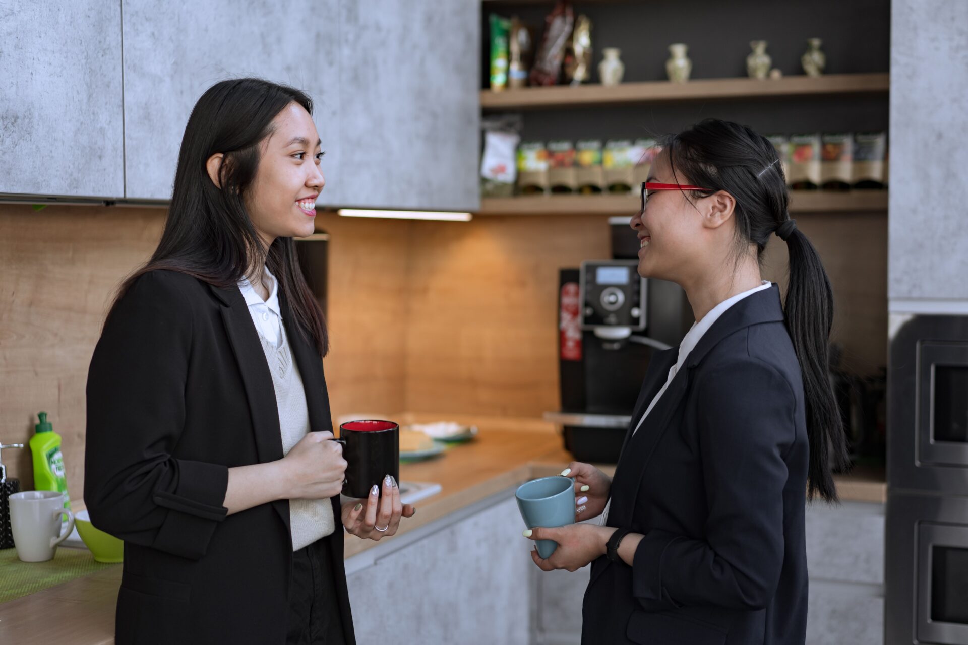 Picture of 2 employees enjoying a coffee in the office breakroom
