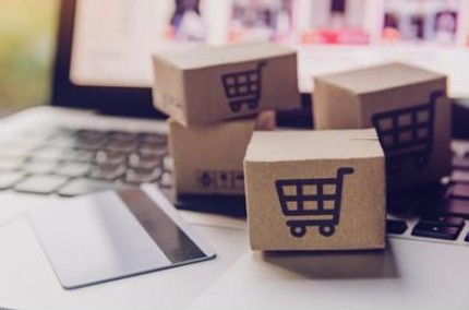 Picture of small cardboard boxes sitting on a keyboard.